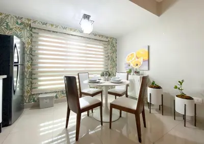 a dining room with a table and chairs and a window at Charming space in the city center in Santo Domingo