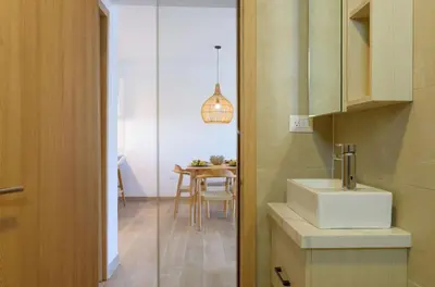 a small kitchen with a sink and a table at Amazing pool views apartment in Playa Bavaro in Punta Cana