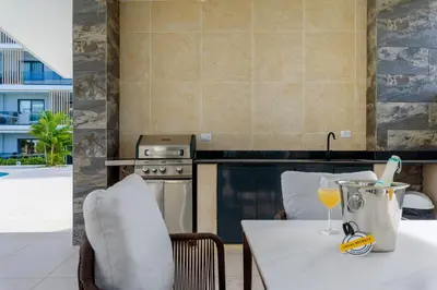 a kitchen with a table with a glass of wine at Amazing pool views apartment in Playa Bavaro in Punta Cana