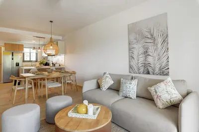 a living room with a couch and a table at Amazing pool views apartment in Playa Bavaro in Punta Cana
