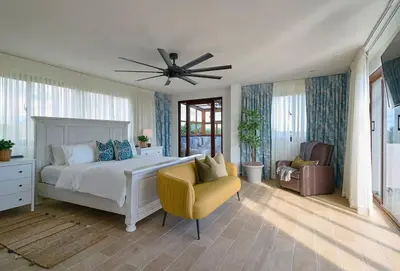 a bedroom with a bed and a ceiling fan at Villa La Chiquita Paradise Pool and BBQ in Baní
