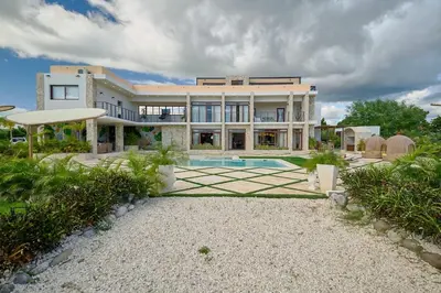 a large house with a swimming pool in front of it at Villa La Chiquita Paradise Pool and BBQ in Baní