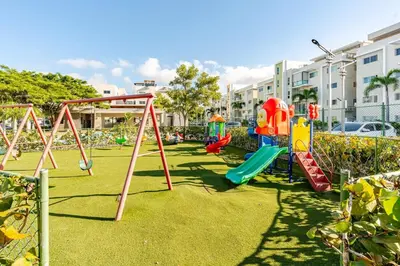 a park with a playground with a swing set at Chic Urban Retreat with Pool, Gym, & Free Parking in Santiago de los Caballeros