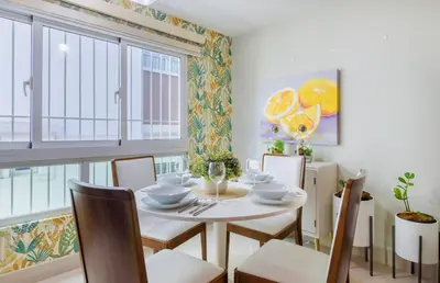 a dining room with a white table and chairs at La Condesa del Vergel in Santo Domingo