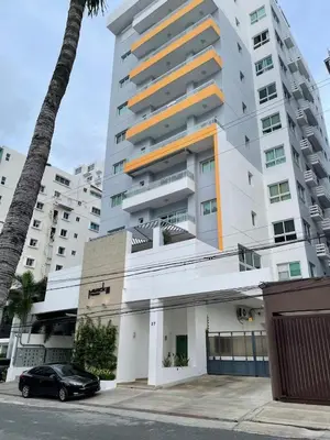 a black car parked in front of a tall building at La Condesa del Vergel in Santo Domingo