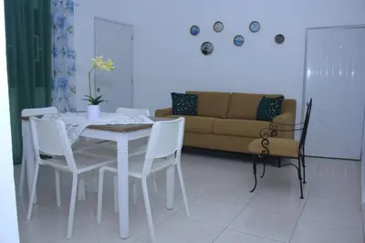a table and chairs in a living room with a couch at RGgrup in Pantoja