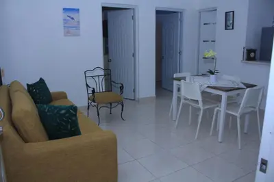 a living room with a couch and a table and chairs at RGgrup in Pantoja