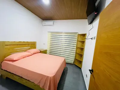 a small bedroom with a bed and a closet at Villa Estela Jarabacoa in Jarabacoa