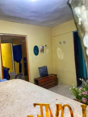a living room with a table and a room with a roomswers at Rincón del Mojito in Santa Cruz de Barahona
