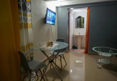 a room with a table and chairs and a television at Casa Ballenas2 in Las Terrenas