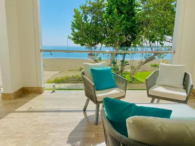 a living room with chairs and a view of the ocean at Escape-Fortunity 1 in San Felipe de Puerto Plata