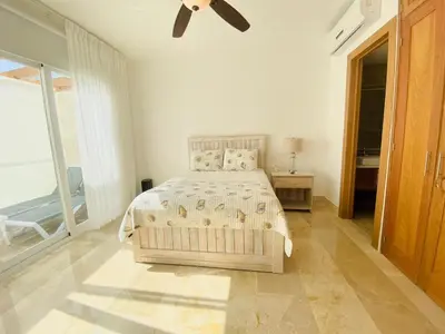 a bedroom with a bed and a ceiling fan at Escape-Fortunity 1 in San Felipe de Puerto Plata