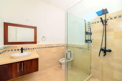a bathroom with a shower and a sink and a toilet at Bluegreen Oceanfront Condo at Laguna Beach in Sosúa