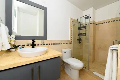 a bathroom with a sink and a toilet and a shower at Bluegreen Oceanfront Condo at Laguna Beach in Sosúa
