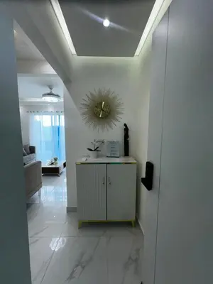 a hallway with a mirror on the wall and a table at Santo Domingo Este Stylish Condo in San Isidro