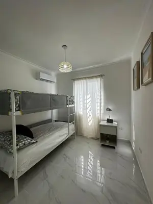 a bedroom with a bunk bed and a table at Santo Domingo Este Stylish Condo in San Isidro