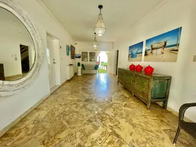 a hallway with a mirror and a dresser in a room at Spacious apartment beach access in Juan Dolio