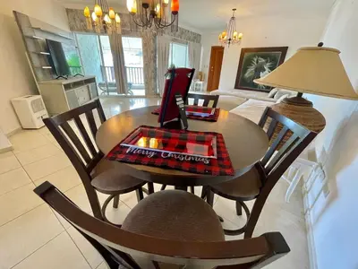 a dining room table and chairs in a living room at Spacious apartment beach access in Juan Dolio