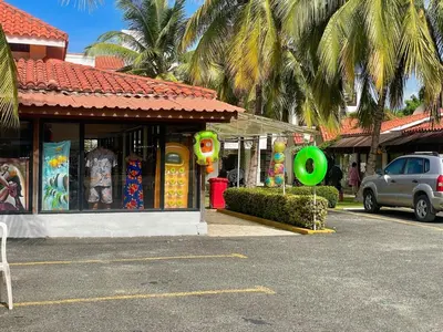 a car parked in a parking lot in front of a store at Spacious apartment beach access in Juan Dolio