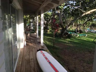 a surfboard sitting on the porch of a house at Villa Bianca - BEACHFRONT with Pool in Sosúa