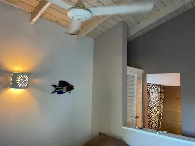 a room with a mirror and a lamp on the wall at Villa Bianca - BEACHFRONT with Pool in Sosúa