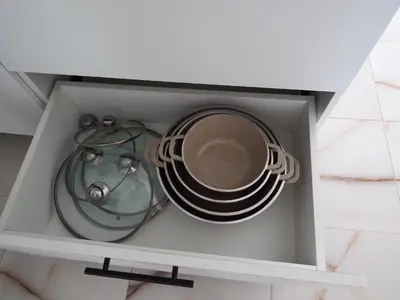 a cabinet with a cup and plates and a tea set at APE Dream Villa in Itabo