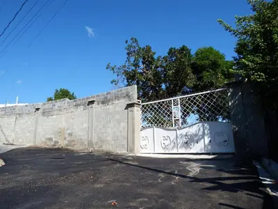 a fence with a gate with graffiti on it at APE Dream Villa in Itabo