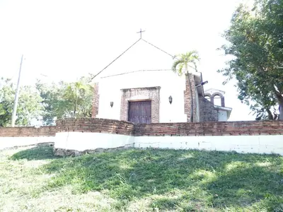 an old white church with a brick fence at APE Dream Villa in Itabo