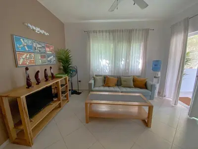 a living room with a couch and a coffee table at Gorgeous apartment steps to Playa Punta Popy in Las Terrenas
