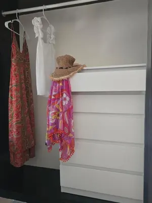 a closet with two dresses and a hat at Casa CASTILLO in La Laguna