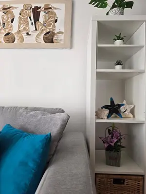 a room with a couch and a shelf with shoes at Casa CASTILLO in La Laguna