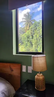 a bedroom with a window and a table with a lamp at Boho villas and spa in El Valle