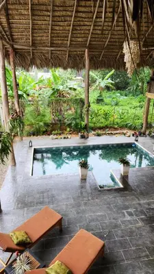 a swimming pool in a resort with two loungers at Boho villas and spa in El Valle