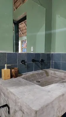 a bathroom with a sink and a mirror at Boho villas and spa in El Valle