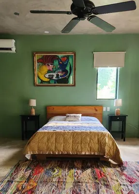 a bedroom with a bed and a ceiling fan at Boho villas and spa in El Valle