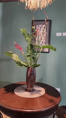 a vase with flowers sitting on a table at Boho villas and spa in El Valle