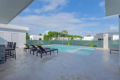 a swimming pool with lounge chairs and a swimming pool at Beautiful villa in the Caribbean! in Sosúa