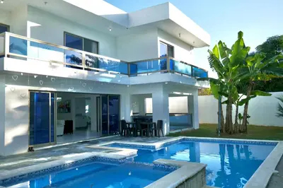 a house with a swimming pool in front of it at Villa Pravda Paradise Guerra in La Caoba