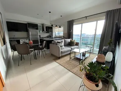 a kitchen and living room with a couch and a table at Armonia 17 suites by Yellowkey in Santo Domingo