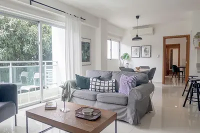 a living room with a couch and a table at Armonia 17 suites by Yellowkey in Santo Domingo