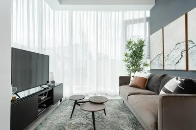 a living room with a couch and a flat screen tv at Armonia 30 suites by Yellowkey in Los Prados