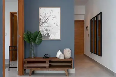 a hallway with a table with a vase on it at Armonia 30 suites by Yellowkey in Los Prados