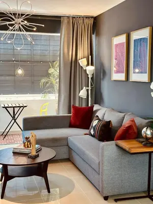 a living room with a couch and a table at Acogedor Penthouse de 2 habitación in Santiago de los Caballeros