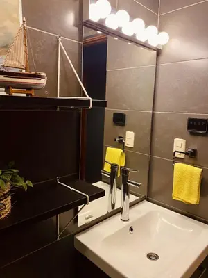 a bathroom with a sink and a mirror at Acogedor Penthouse de 2 habitación in Santiago de los Caballeros
