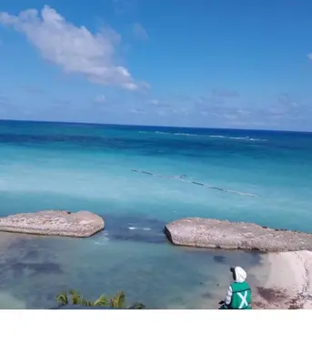 a person sitting on the beach looking at the ocean at Punta cana in El Seis