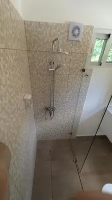 a shower with a glass door in a bathroom at Spacious Apartment w Pool in Las Terrenas