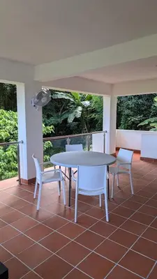 a white table and chairs on a patio at Spacious Apartment w Pool in Las Terrenas
