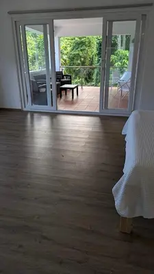 a room with a wooden floor and sliding glass doors at Spacious Apartment w Pool in Las Terrenas