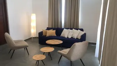 a living room with a blue couch and chairs and tables at Casa Playa Rincon Hills Samana Las Galeras by BTC Group Crypto in Castellalito