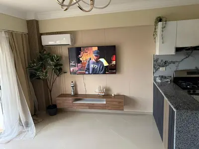a living room with a tv on the wall at Boca chica retreat in Boca Chica